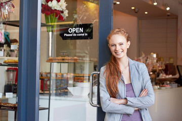 Shes the proud owner of this bakery. Portrait of an attractive young woman standing confidently in...