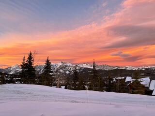 Fototapeta premium Dramatic and colourful sunset skies over Gallatin Peak as seen from Big Sky, Montana on a winter day