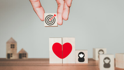 Dating Ideas for Marriage Goals. Man holding a wooden cube block with a target icon when he meets a...