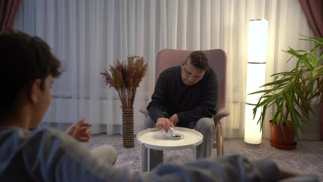Fortune teller is telling fortunes.
He looks at the coffee fortune of the person standing in front of him. The fortune teller interprets and explains.
