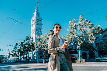 busy beautiful asian japanese woman manager with coffee walking near ferry building in san...