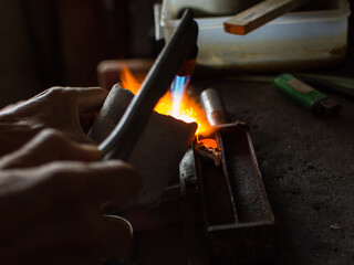 goldsmith working in a fireplace