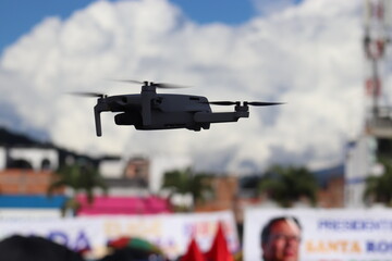 silhouette of a commercial drone flying in a blue sky