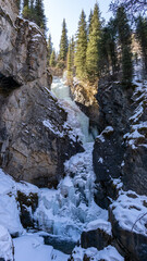 Beautiful frozen waterfall in a mountain gorge
