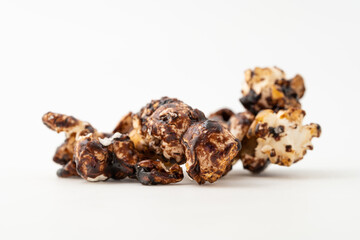 Chocolate caramel popcorn on a solid background