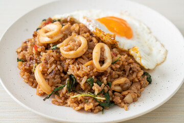 fried rice with squid and basil topped fried egg in Thai style