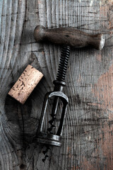 old  corkscrew on wooden background