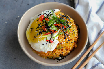 Homemade traditional Korean meal. Kimchi Fried Rice & Fried Egg. Short grain rice with imported Korean pickled vegetables, chili, seaweed strips, fried egg, black & white sesame seeds, green onions