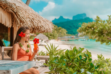 Breakfast at luxury hotel room on beach. Asian woman drinking fruit juice morning on summer...