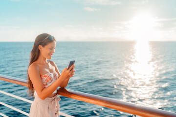Cruise travel vacation Asian lady using smartphone on holidays in Caribbean. Happy young woman texting online.
