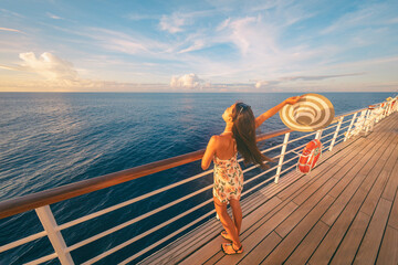 Cruise ship fun happy travel tourist woman enjoying sunset on deck feeling free with open arm relaxing at scenic view of ocean. © Maridav