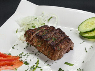 Grilled beef steak served onion