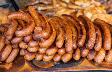 Traditional fatty german street food - fried sausages on plate in market