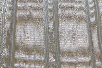 Close-up photo of polyethylene foam (PE foam) insulation panels installed on residential roofs.