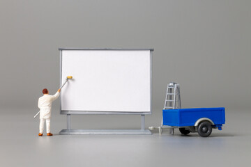 Miniature people Painter at The front of a whiteboard