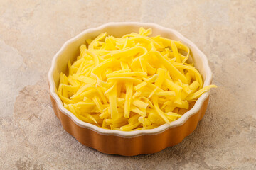 Shredded yellow cheese in the bowl