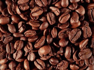 Antique vintage retro bronze coffee mill on black wooden board with roasted coffee beans