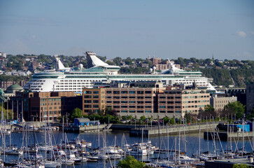 Modern big cruiseship or cruise ship liner in port of Quebec City, Canada with Chateau Frontenac...