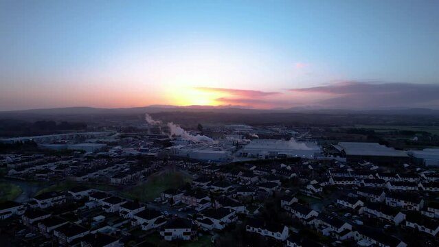 Sunrise in the early morning over the small rural town with a factory starting its work Sallins Naas