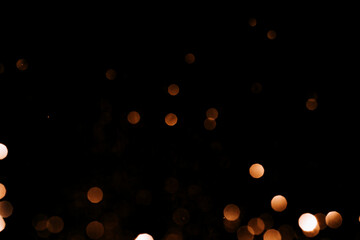 Golden garlands close-up against black background.