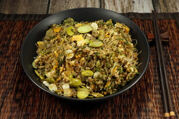 Traditional fried and stirred glass vermicelli with bitter bean serving on the bowl. Famous spicy street food menu in Asia. 