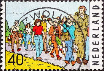 Netherlands - circa 1976 : a postage stamp from the Netherlands, showing a crowd at the 60th Four...