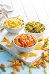 Three colors fusilli pasta. Colorful italian raw pasta in bowl.