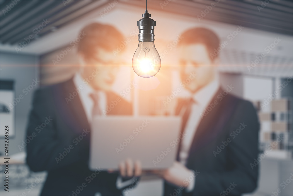 Poster blurry businesspeople with laptop working together on abstract office interior background with glowi