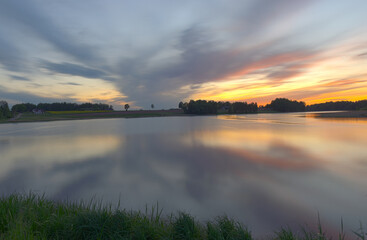 Fototapeta na wymiar blurred panoramic view, colorful sunset landscape on the lake, long-term exposure