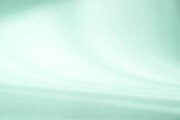 Abstract light green studio background for product presentation. Empty room with shadows of window. Display product with blurred backdrop.