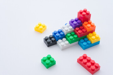 Close up color plastic block is build staircase on white background copy space. Business and finance strategy, teamwork, business management, creative idea concept. Planning is key success to target.