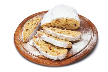Sliced Traditional Christmas stollen cake with marzipan and dried fruit isolated on white background
