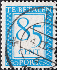 Netherlands - circa 1950 : a postage stamp from the Netherlands , showing a number with an...