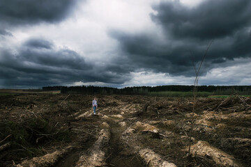 A boy and a girl in the ruins of their village.black clouds.On the site of the former forest,...