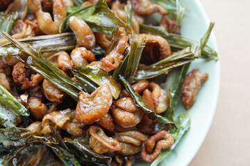 Crispy fried intestines and herbs on dish. Concept : Weird food. Delicious menu in Thailand. Best to eat with beer or eat as appetizer.        