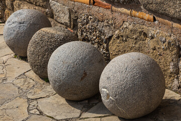 decorative smooth stone spheres along the facade of the building and sidewalk. design and architecture.