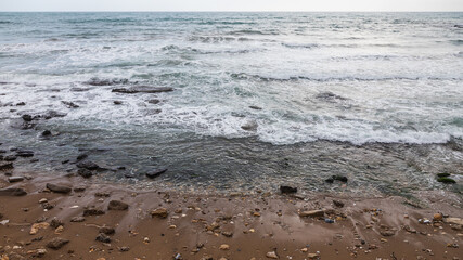 Morning bright blue skies with transparent white clouds and restless deep sea. Feeling calm, cool, relaxed.