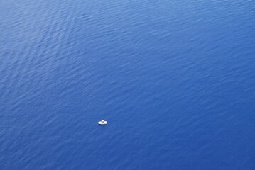 White boat on blue ocean. Aerial view.