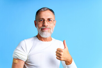 Healthy mature man getting vaccinated immunity blue background studio