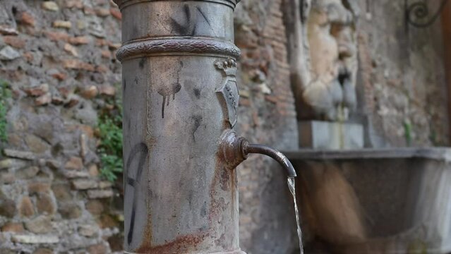 A typical fountain named "nasone" of Rome on the aventino, Italy.