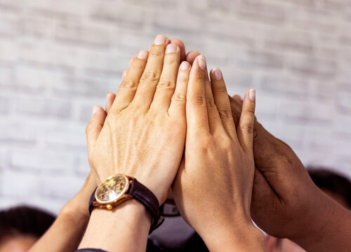 Selective focus of hands in hi five team work  which  hands of team , the business Unity and teamwork concept