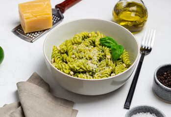 Fusilli pasta with pesto sauce, cheese and nuts. Healthy eating. Vegetarian food. Italian cuisine.