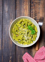 Fusilli pasta with pesto sauce, cheese and nuts. Healthy eating. Vegetarian food. Italian cuisine.