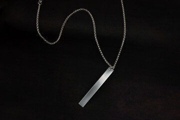 Fototapeta na wymiar Silver jewelry chain bracelet necklace isolated on black engraving plate