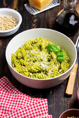 Fusilli pasta with pesto sauce, cheese and nuts. Healthy eating. Vegetarian food. Italian cuisine.