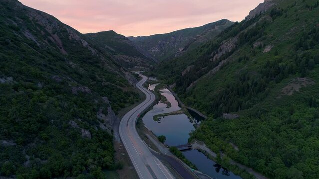 Flying through Provo Canyon over highway 189 and Provo River at dusk in Utah.