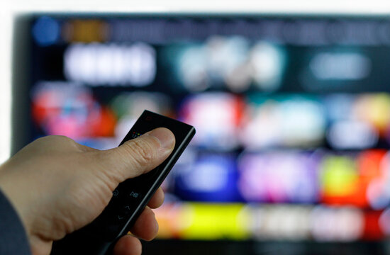 Remote control and screen - binge watching the favorite TV show