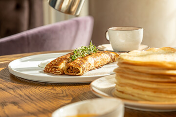 traditional Russian pastries: pancakes for Maslenitsa, pancakes with salmon, pancakes with honey, pancakes for breakfast