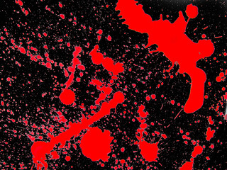 red drops of paint on a black background