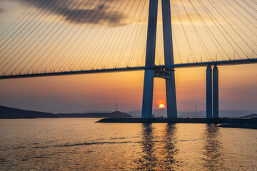 Obraz premium Sunset view of long cable-stayed bridge in Vladivostok, Far East of Russia